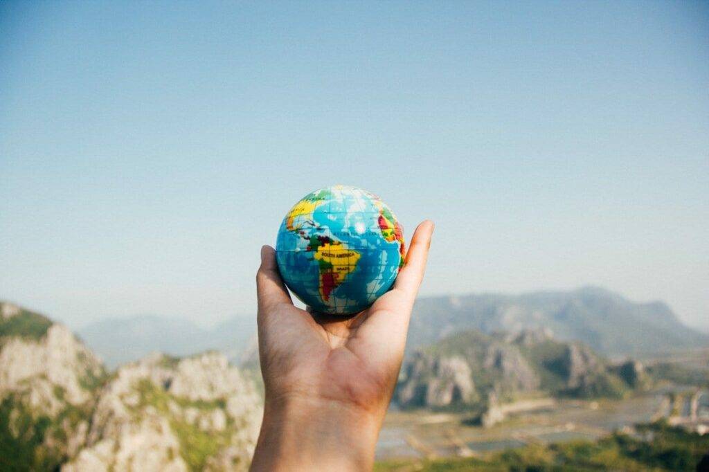 Hand holding a small globe