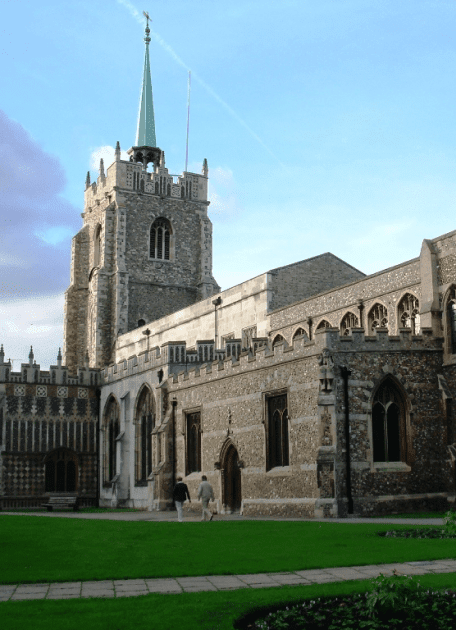 A church courtyard and two people walking in it