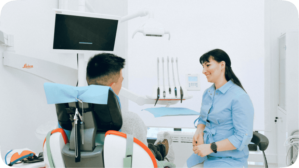 Man sitting down at a doctor's examination room and doctor sitting next to them